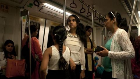 Indian commuters travel in the compartment reserved for women on the metro in New Delhi, India, on June 10, 2015