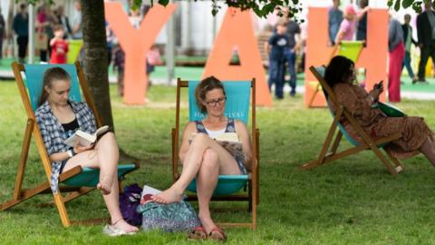 Two women reading books at Hay