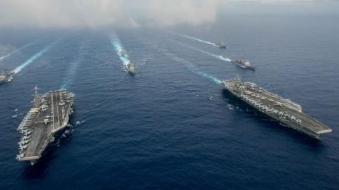 US Nimitz-class aircraft carriers USS John C. Stennis (L) and USS Ronald Reagan (CVN 76) with their escorts in th Pacific Ocean