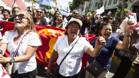 Supporters of Peruvian former president Alan Garcia escort the coffin