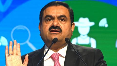 Indian billionaire Gautam Adani faces critical report before family-run company goes public.