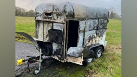 Fire damaged horse box where equipment was stored