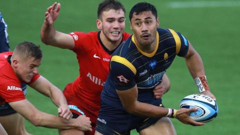 Worcester full-back Melani Nanai is tackled by Ali Crossdale and Charlie Watson of Saracens