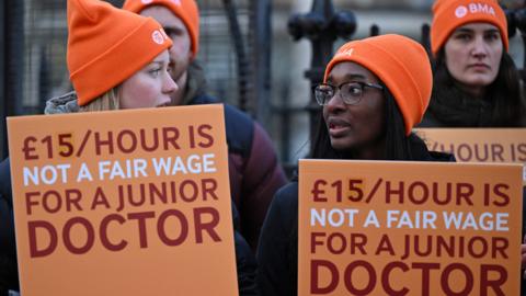 People hold placards during the junior doctors strike in January