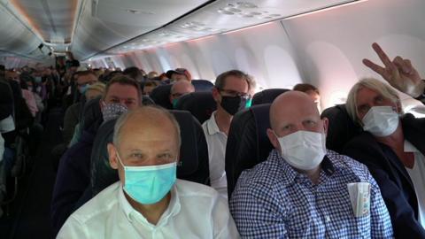 Masked passengers on a plane