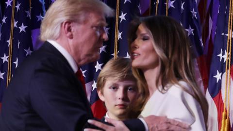 Republican president-elect Donald Trump embraces his wife Melania Trump, as their son Barron looks on