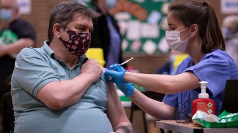 A man being vaccinated by a nurse in Newbridge