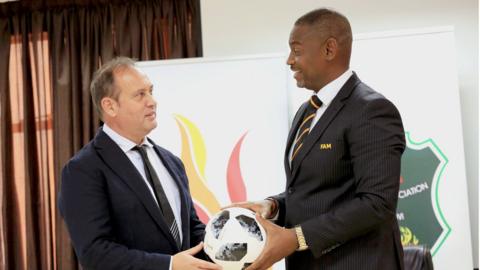 Mario Marinica and FA Malawi boss Walter Nyamilandu