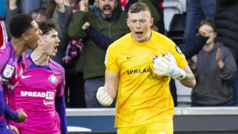 Anthony Patterson celebrates saving a penalty