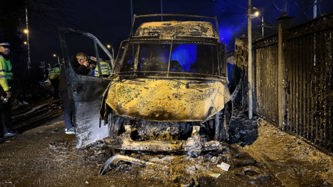 A burnt out police van