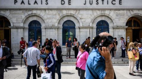 Journalists gather outside the courthouse in Valence for the trial of Gabriel Fortin, 13 June