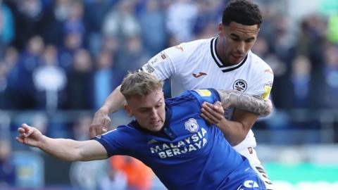 Isaak Davies of Cardiff City challenged by Ben Cabango of Swansea City