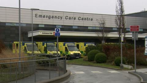A row of ambulances parked outside an emergency care centre
