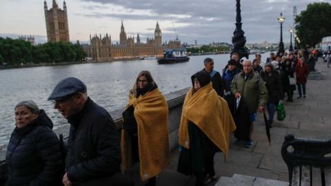 People queue to pay their respects to Queen Elizabeth II lying in state.