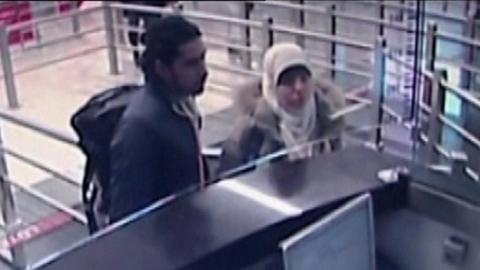 Hayat Boumeddiene with an unidentified man at passport control