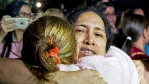 Maria Perez hugs her family after her release