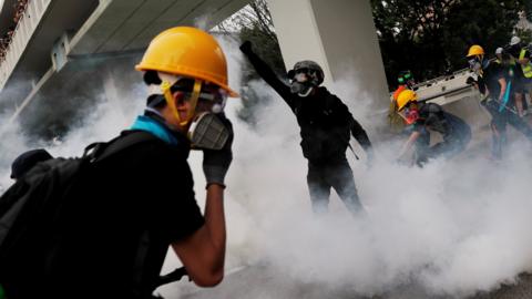 Demonstrators react to a tear gas during a protest against the Yuen Long attacks in Yuen Long, New Territories, Hong Kong, China July 27, 2019.