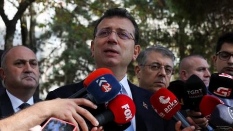 Ekrem Imamoglu speaking to reporters about the case against him