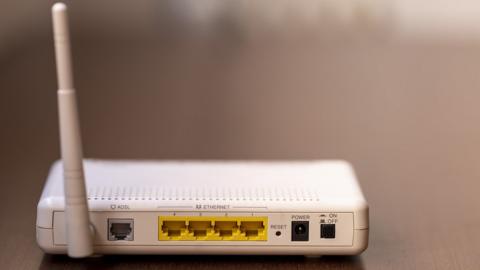 A stock image of an internet router sitting on a table