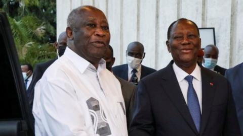 Ivory Coast"s President Alassane Ouattara shakes hands with former President Laurent Gbagbo