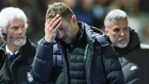 Gary Rowett walks off the field after seeing his Birmingham City side lose to Cardiff
