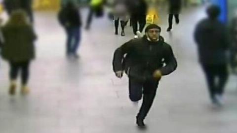 A man in a CCTV image running