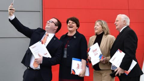 A DUP election candidate takes a selfie with party colleagues and leader Arlene Foster