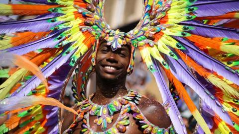 A reveller takes part in the Notting Hill Carnival in 202