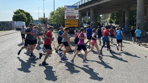 Runners going round a bend near the Cumberland Basin in Bristol as part of the 10k