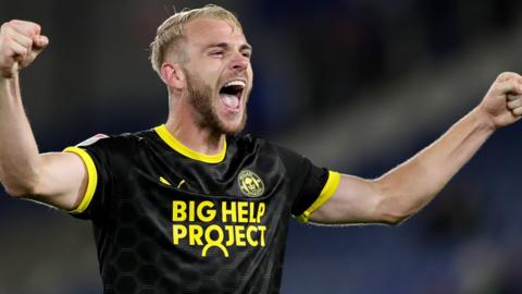 Jack Whatmough celebrates a win for Wigan Athletic