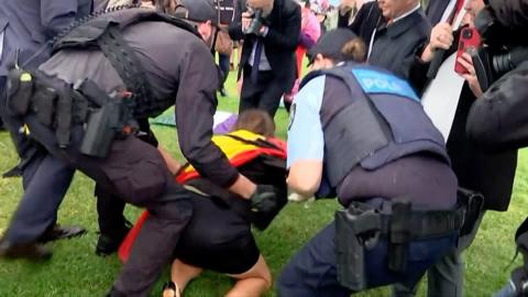 Senator Lidia Thorpe surrounded by police