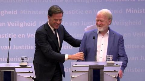 Dutch PM laughing after shaking hands with health official