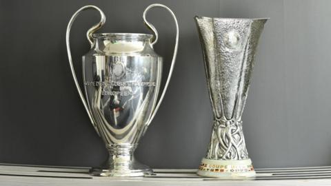 Champions League and Europa League trophies