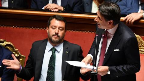 Italian Prime Minister Giuseppe Conte (R) is flanked by Deputy Prime Ministers Matteo Salvini (L)