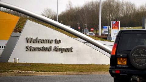 Stansted airport sign with car