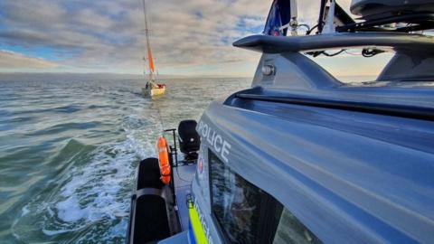 The police boat approaches the yacht