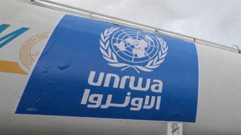A truck, marked with United Nations Relief and Works Agency (UNRWA) logo
