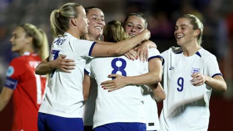 England players celebrate with Grace Clinton