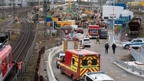 Police and firefighters secure the scene after an old aircraft bomb exploded during construction work at a bridge the busy main train station in Munich on 1 Dec