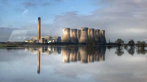 Eggborough power station in North Yorkshire is reflected in floodwater from the River Aire