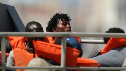 Rescued migrants arrive on an Armed Forces of Malta vessel at its base in Marsamxett Harbour, Valletta