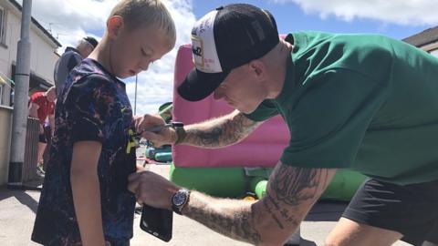 James McClean signs a fan's shirt