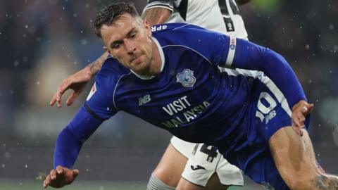 Aaron Ramsey of Cardiff City is tackled against Swansea City