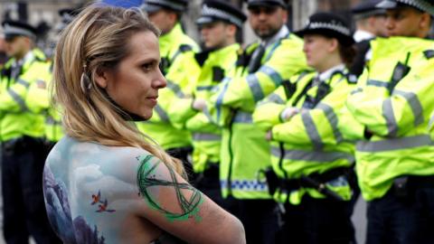 Extinction Rebellion protestor faces police in London