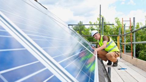 Man fitting solar panel