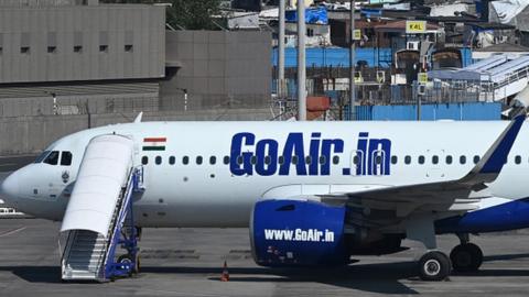 A Go First airline aircraft, formerly known as GoAir, is seen parked at the apron of the Mumbai International airport on May 3, 2023