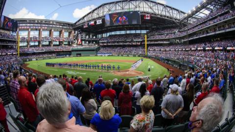 A view of the crowd and the fans and the stands during the playing of the Canadian and USA national anthems before the game between the Texas Rangers and the Toronto Blue Jays at Globe Life Field