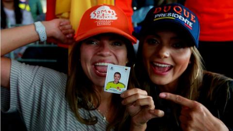 Supporters of presidential candidate Ivan Duque, for the Democratic Centre party, await for the results of the first round of Colombian presidential elections, at the party"s headquarters in Bogota, 27 May