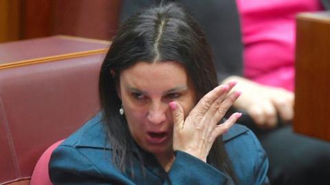 Ms Jacqui Lambie wipes her tears away