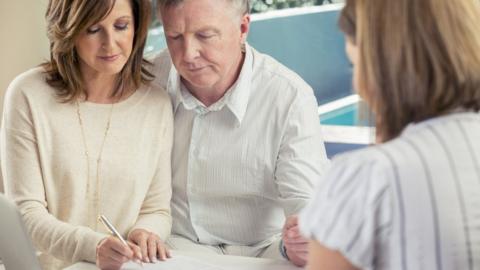 Older couple signing papers